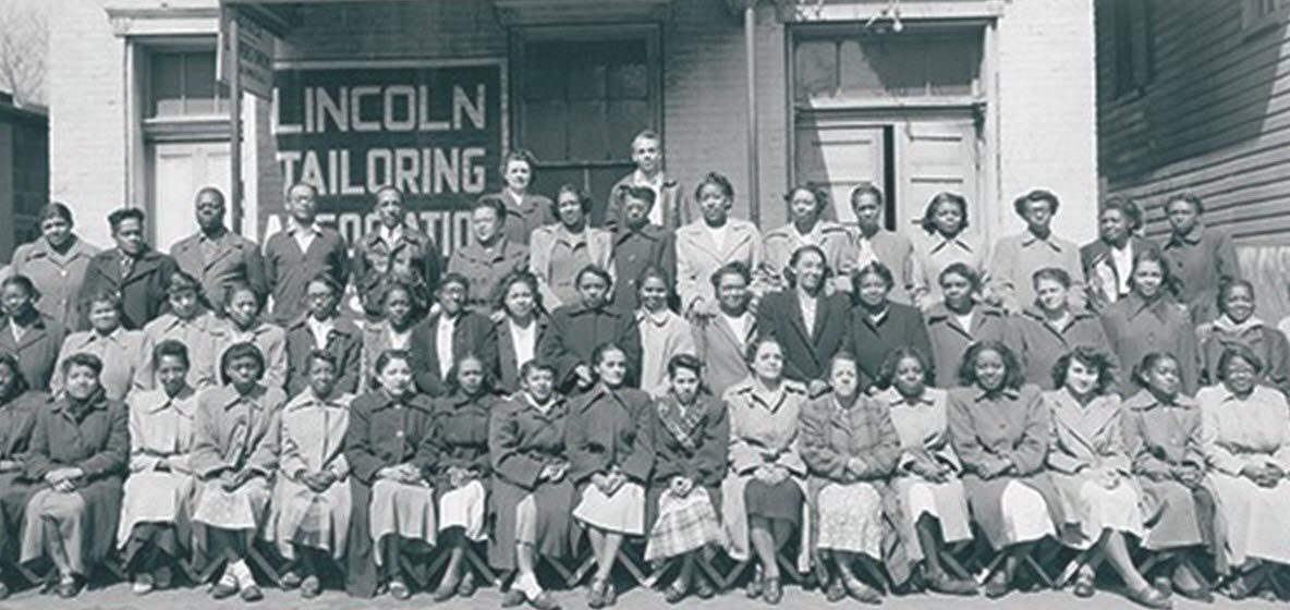 four rows of african american women sit in front of the Lincoln Tailoring Association on All Saints Street