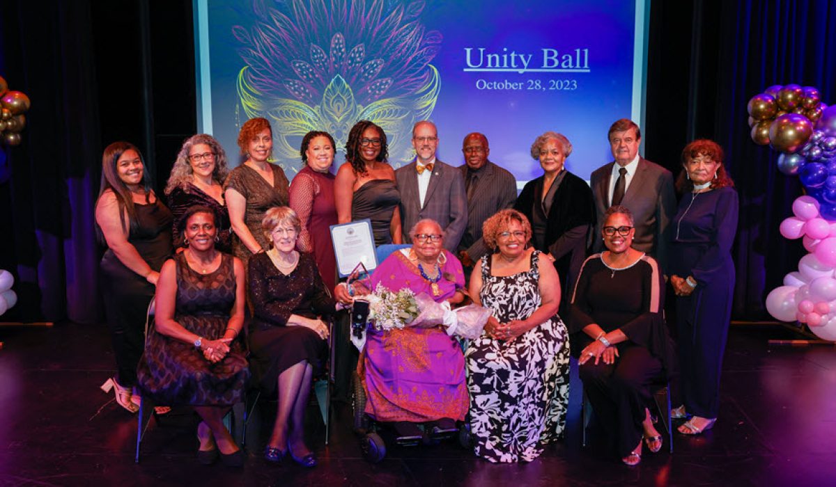 mary harris and aarch society board in front of unity ball backdrop